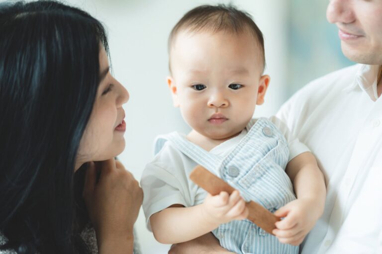 Asian Parents Looking at Their Baby